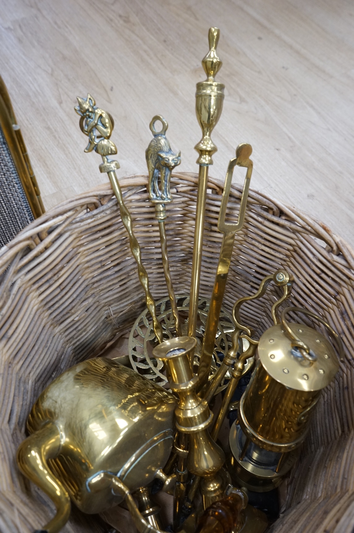 A fire brass guard, pair of candlesticks, kettle, miner's lamp etc, fire guard 54cm high.